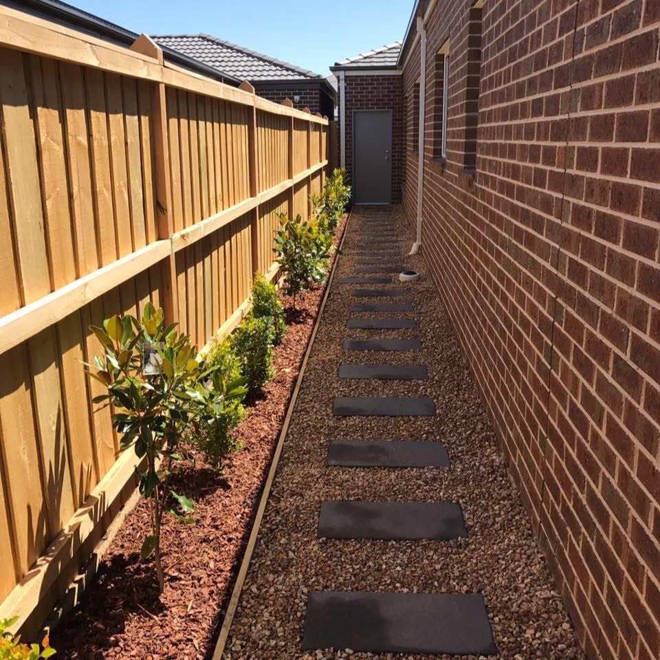 A set of paved steps next to a landscaped garden bed.