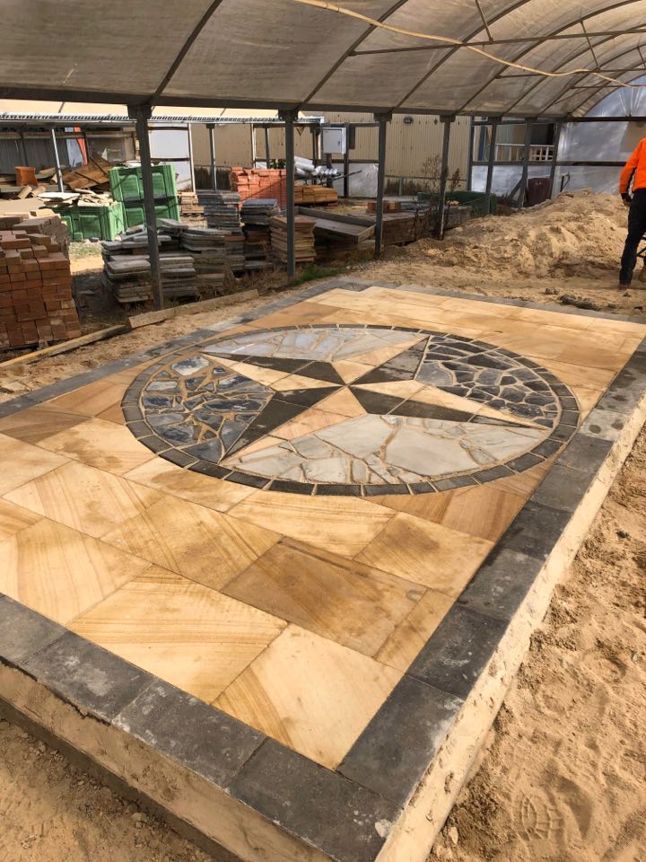 A giant pavement piece with a design of a star in the middle.