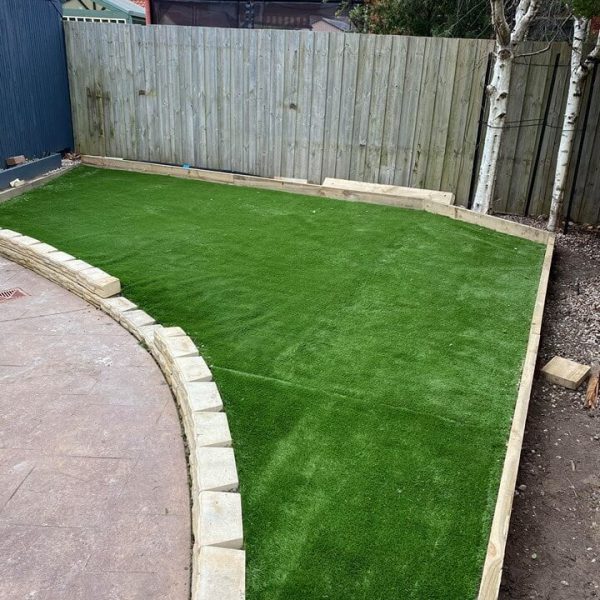 Artificial green turf in a wooden, corner, boxup.